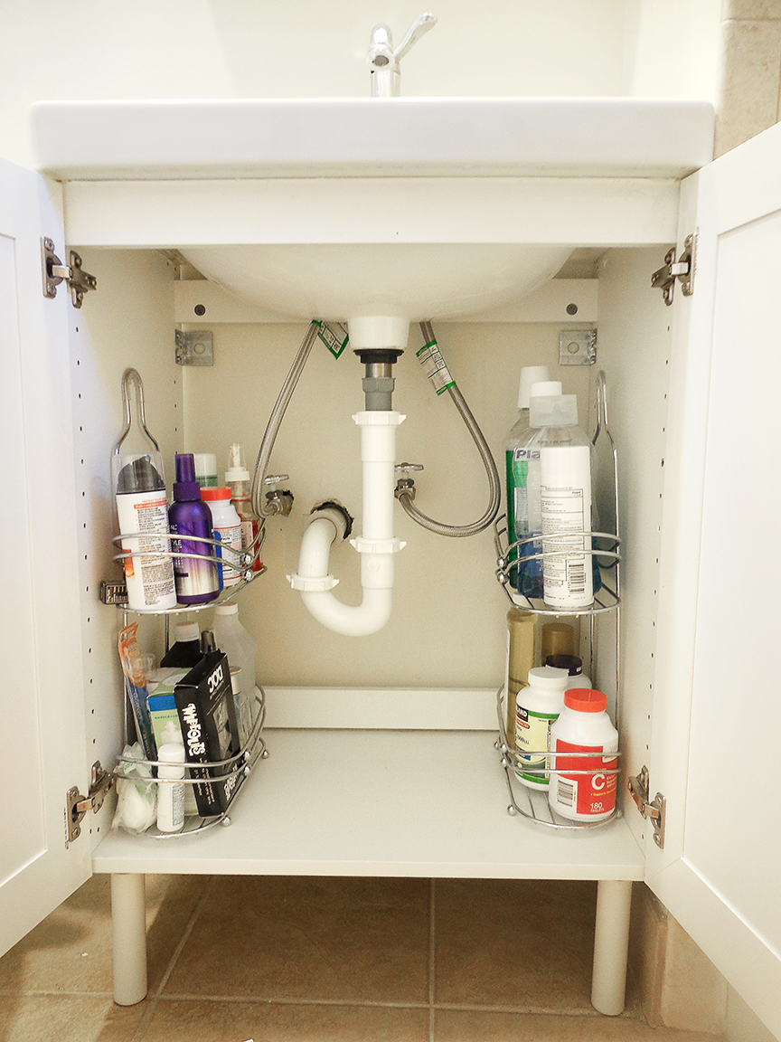 Use a shower caddy as storage shelving under a small sink